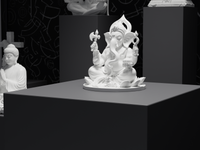 Ganesh murti statue in white, close detail of the face and hands